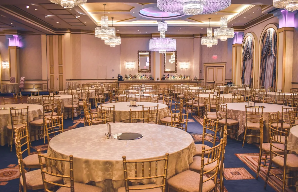 Elegant Kansas City wedding venue ballroom with chandeliers and gold chairs